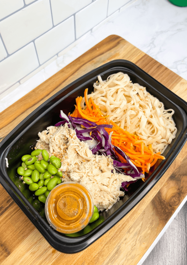 A Thai peanut noodles meal packaged for as a to go meal.